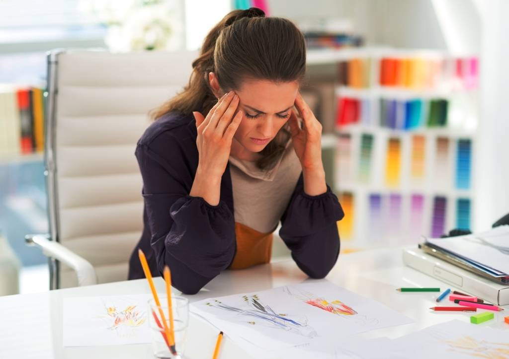 woman looking at drawings stressed out