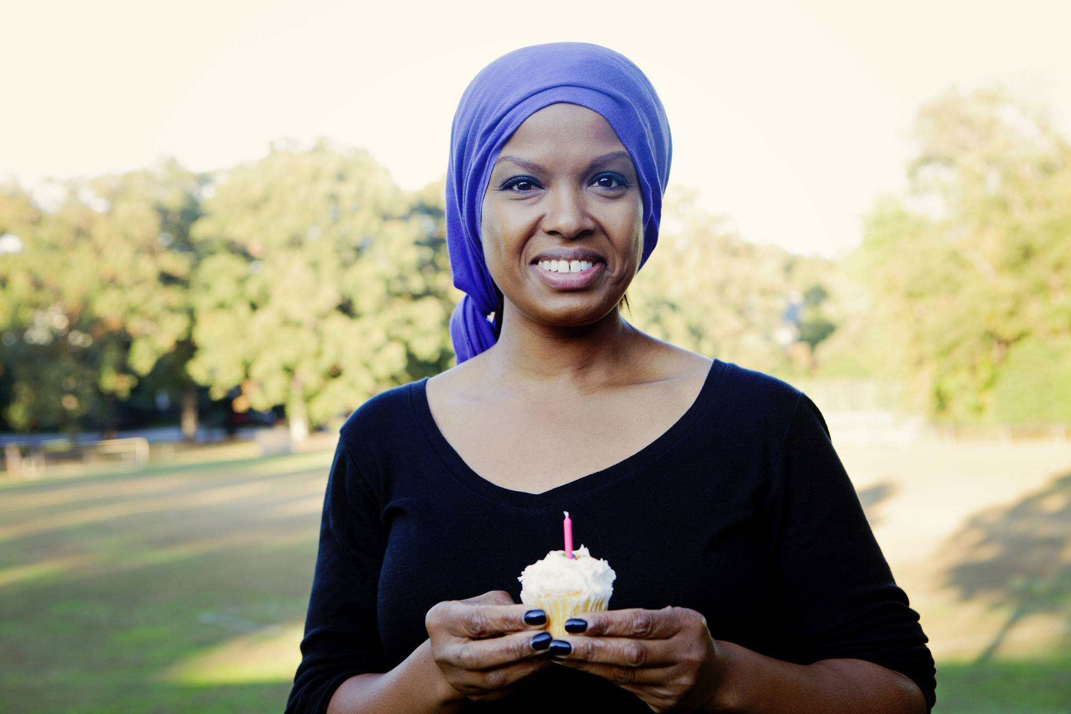 breast cancer survivor holding cupcake