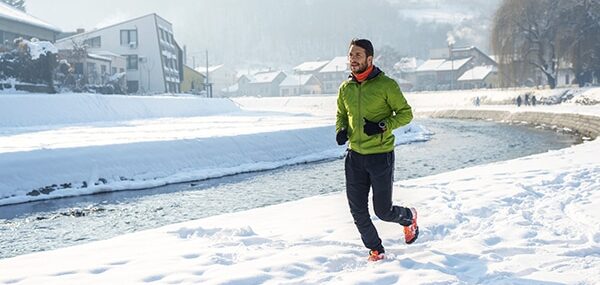 man running in the neighborhood in the snow, cold-weather workout