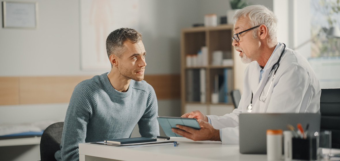 A doctor consults a male patient about a vasectomy procedure