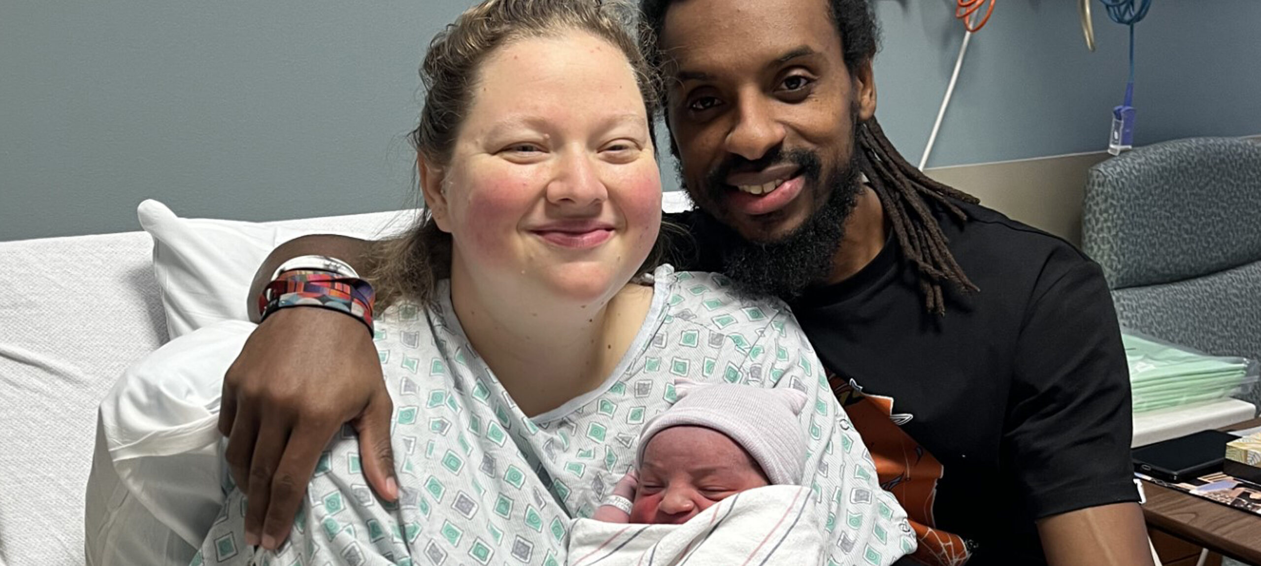 Jesse Mattingly and Desmond Gibbs, holding their newborn baby boy, Kobe Gibbs. Kobe was UofL Health's first baby delivered in 2024.