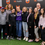 Group photo of LouCity FC, Racing Louisville FC coaches and UofL Health staff