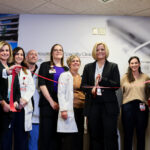 UofL Health team members cutting red ribbon to celebrate the opening of new Multi-Specialty Clinic.