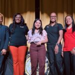 Central High School Student Jocelyn Vasquez poses with the UofL Health and Central High School leadership teams. Jocelyn (center) is holding the Award for Outstanding Service in Trauma Response she received.