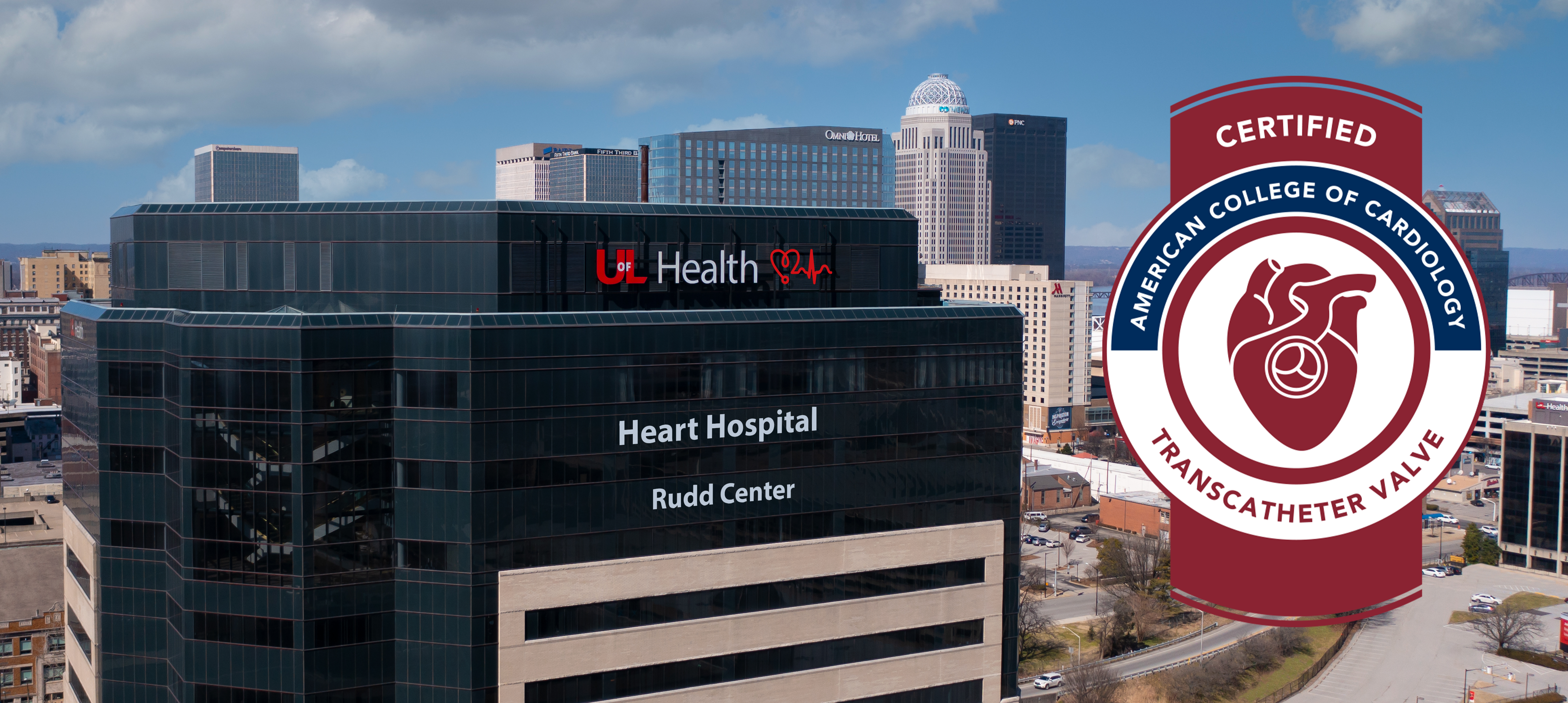 External aerial image of UofL Health – Heart Hospital with the Louisville, Kentucky, skyline in the background. The the American College of Cardiology's achieved Transcatheter Valve certification seal is presented to the right of the building.